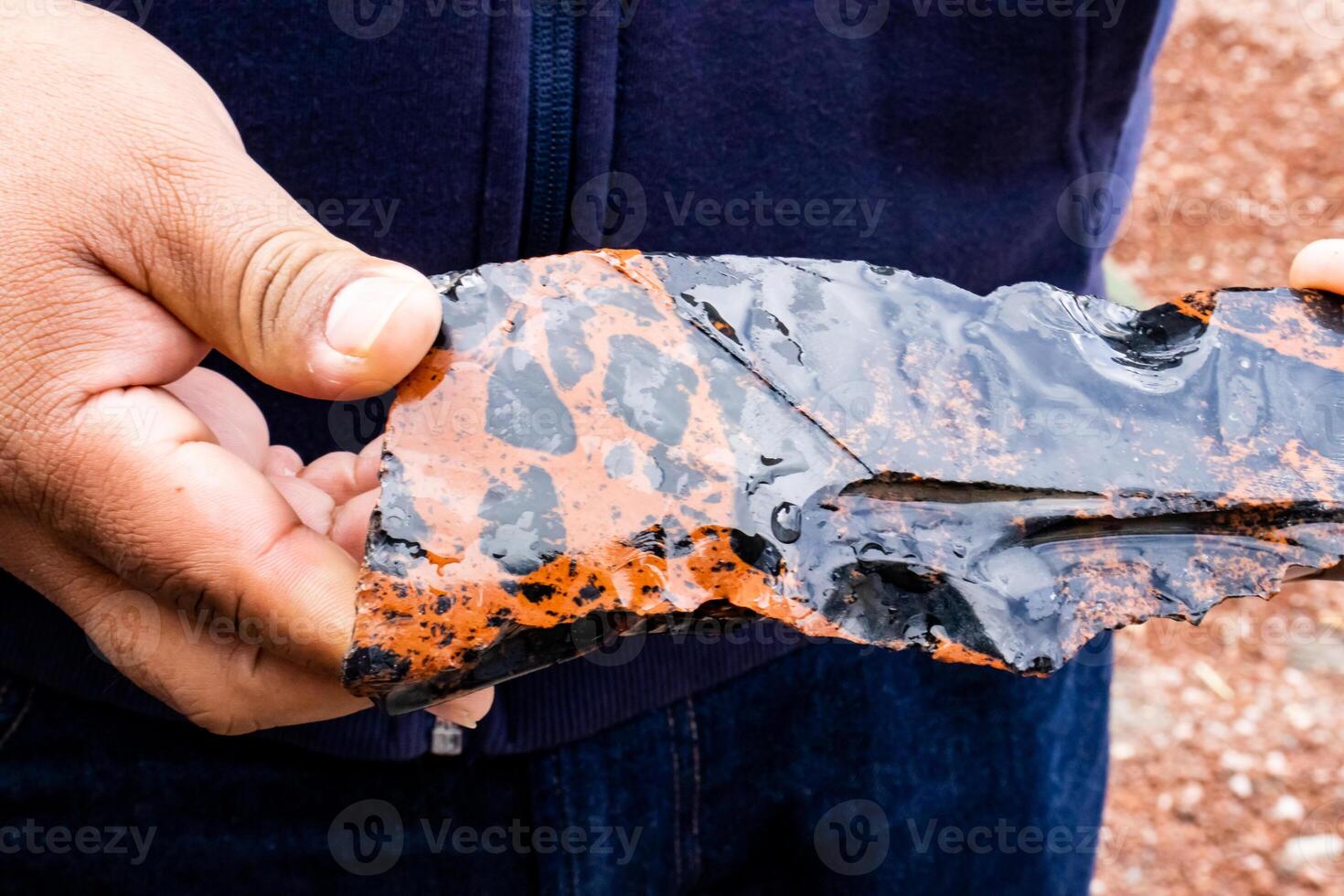Tourist guide showing a colorful obsidian piece to a group of visitors at the Teotihuacan archeological site. photo