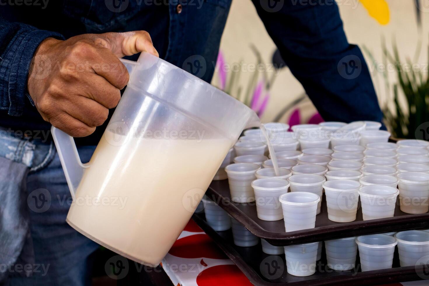Serving traditional pulque drink. Tourist guide showing the importance of the agave plant for the antique cultures to a group of tourists at the Teotihuacan archaeological site. photo