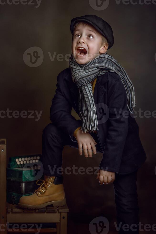 A boy in a suit and scarf is laughing photo