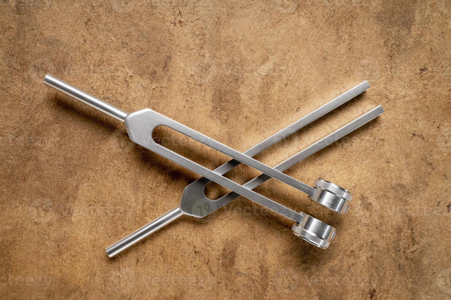 Weighted and unweighted metal tuning forks used for tuning musical instruments, sound therapy, chakra healing photo