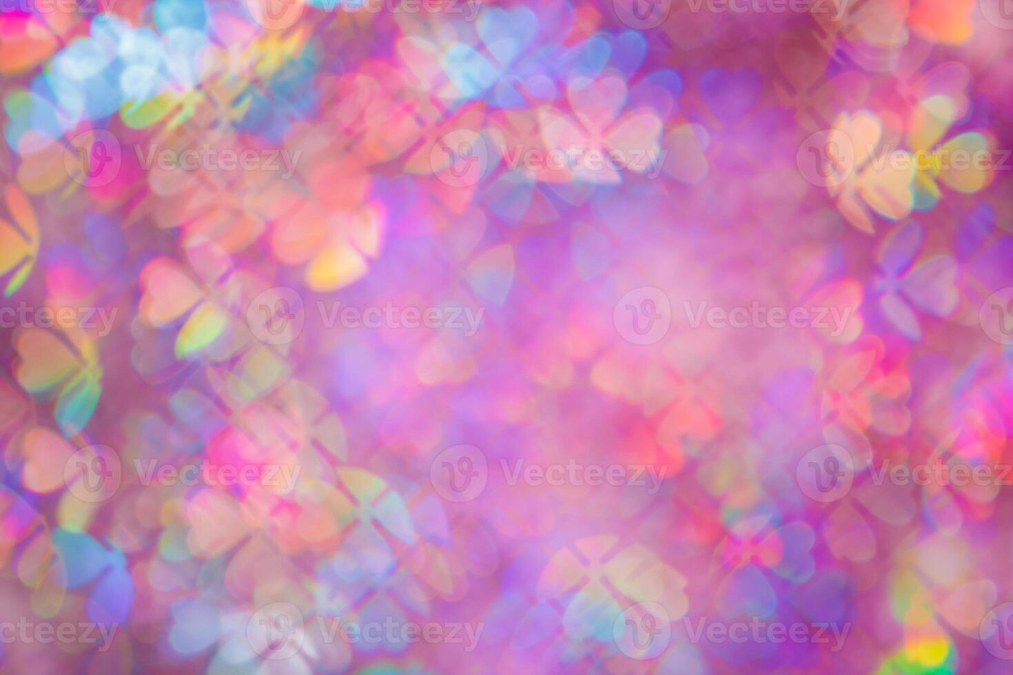 Defocused abstract floral bokeh background purple color, flare from lights, blurred bokeh of clover leaves shape as holiday texture. Colorful festive aesthetic textured lighting pattern photo