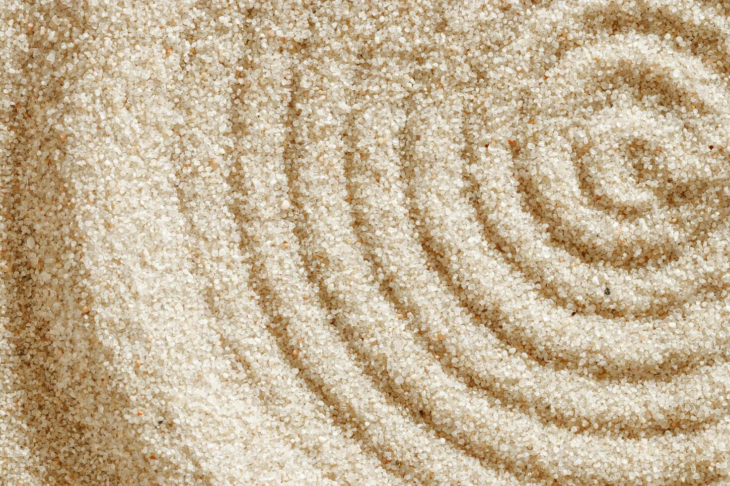Top view pattern in Japanese Zen Garden with close up concentric circles on sand for meditation, relaxation. Aesthetic minimal sandy background with copy space, beige monochrome neutral tones photo