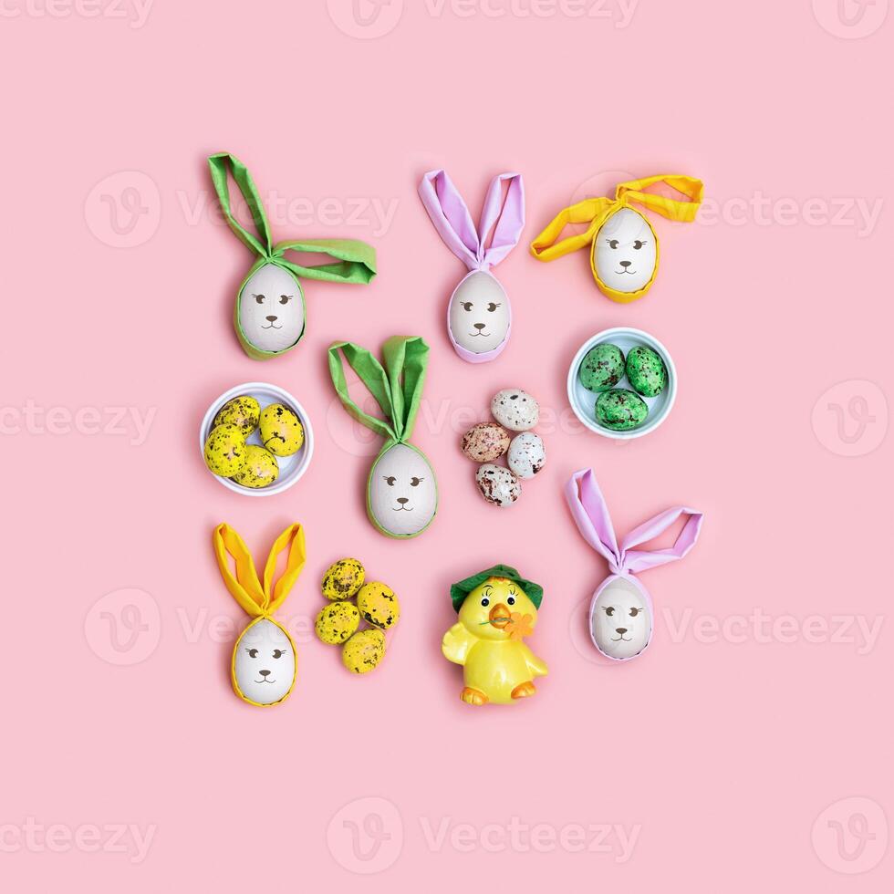 Handmade Easter eggs with Bunny Ears on Pink Background, minimal Flat lay pattern, Easter holiday concept. Creative Spring festive layout. Top view Diy decorated wooden eggs, pastel colors photo