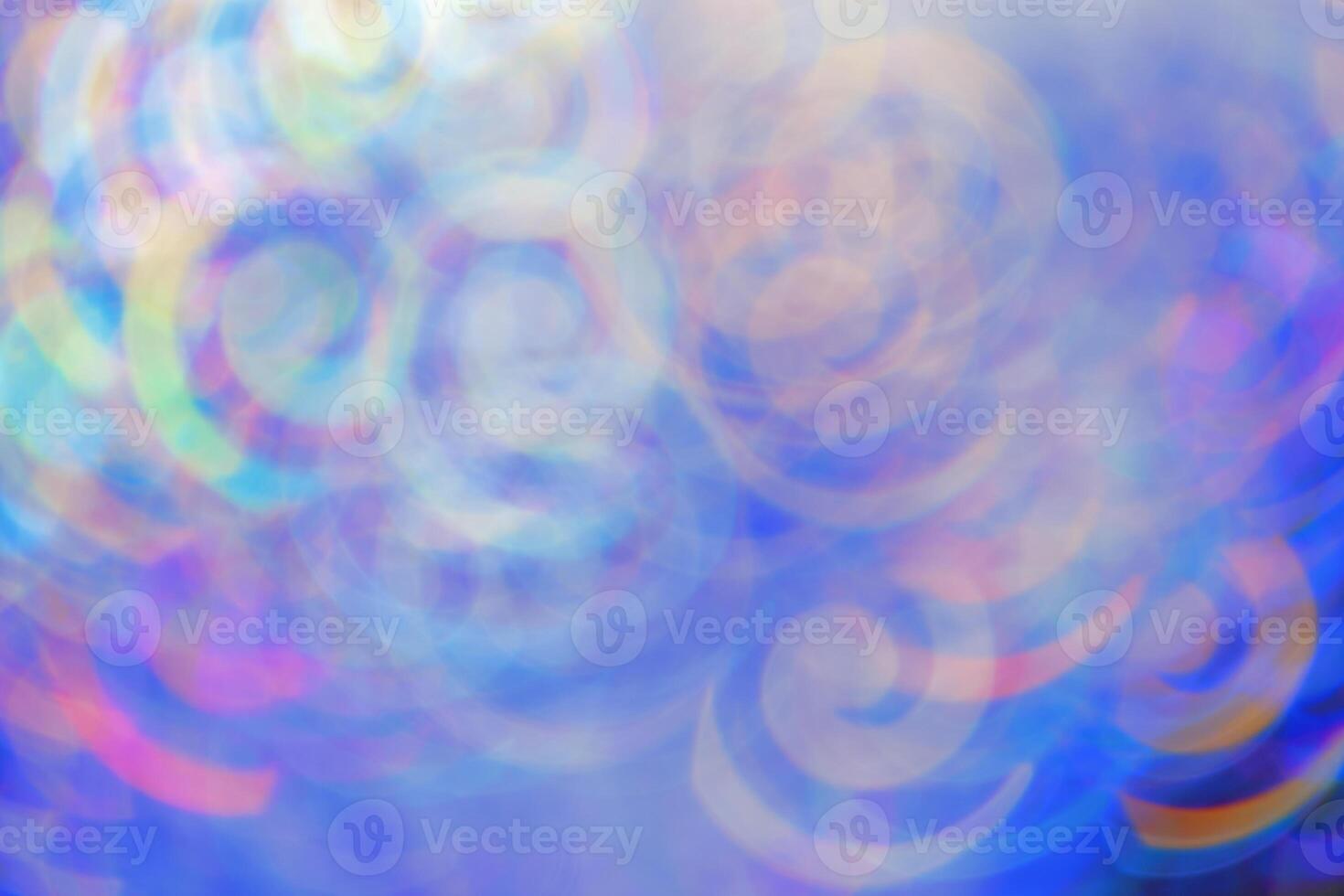 Defocused abstract bokeh background blue lavender colored, flare from lights, color gradient, blurred figured bokeh as holiday texture. Glittering monochrome aesthetic lighting pattern photo