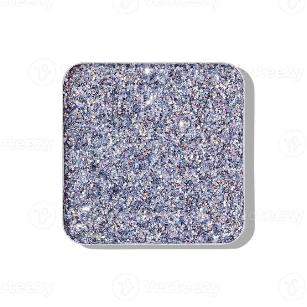 Top view eye shadow glitter silver swatch isolated on white background with shadow, eyeshadow with heart imprint, shiny colored powder for makeup, square shape in metal pack, cosmetic texture photo