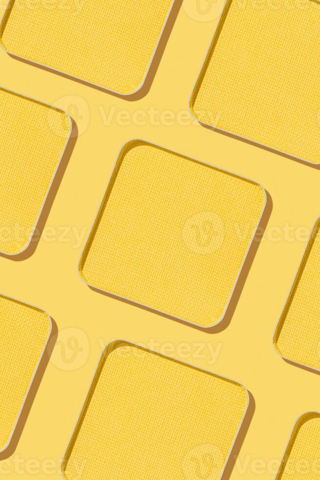 Minimal pattern eye shadow yellow swatches with shadow, monochrome photoas background, refill compact eyeshadow, shiny colored powder for makeup, square shape metal pack, cosmetic texture photo