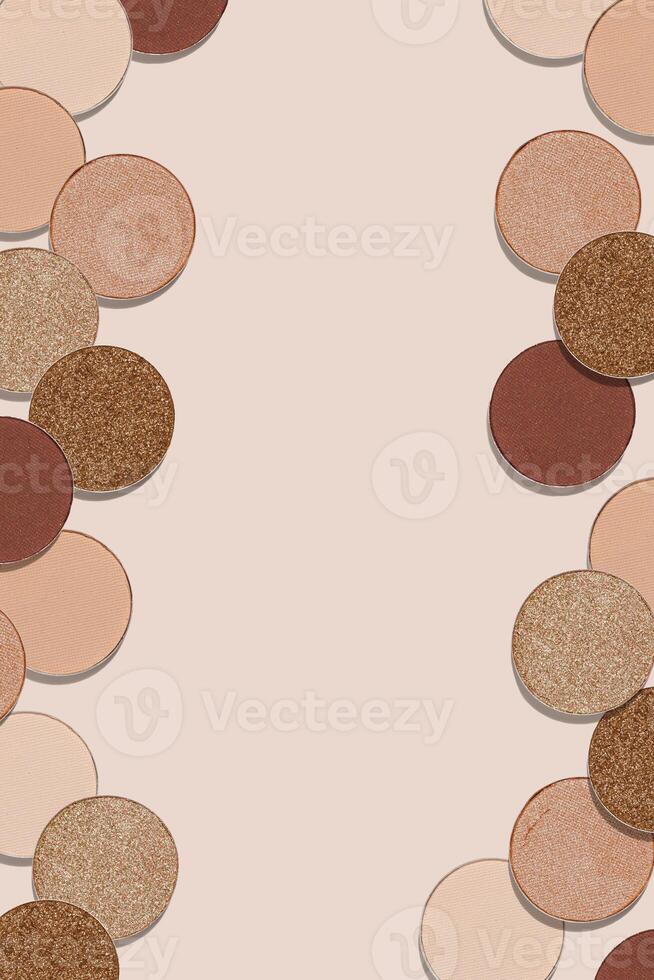 Creative frame with eye shadow swatches, beige brown skin tone colors on beige background, copy space. Eyeshadows powder for makeup, cosmetic design minimal style, top view beauty backdrop photo