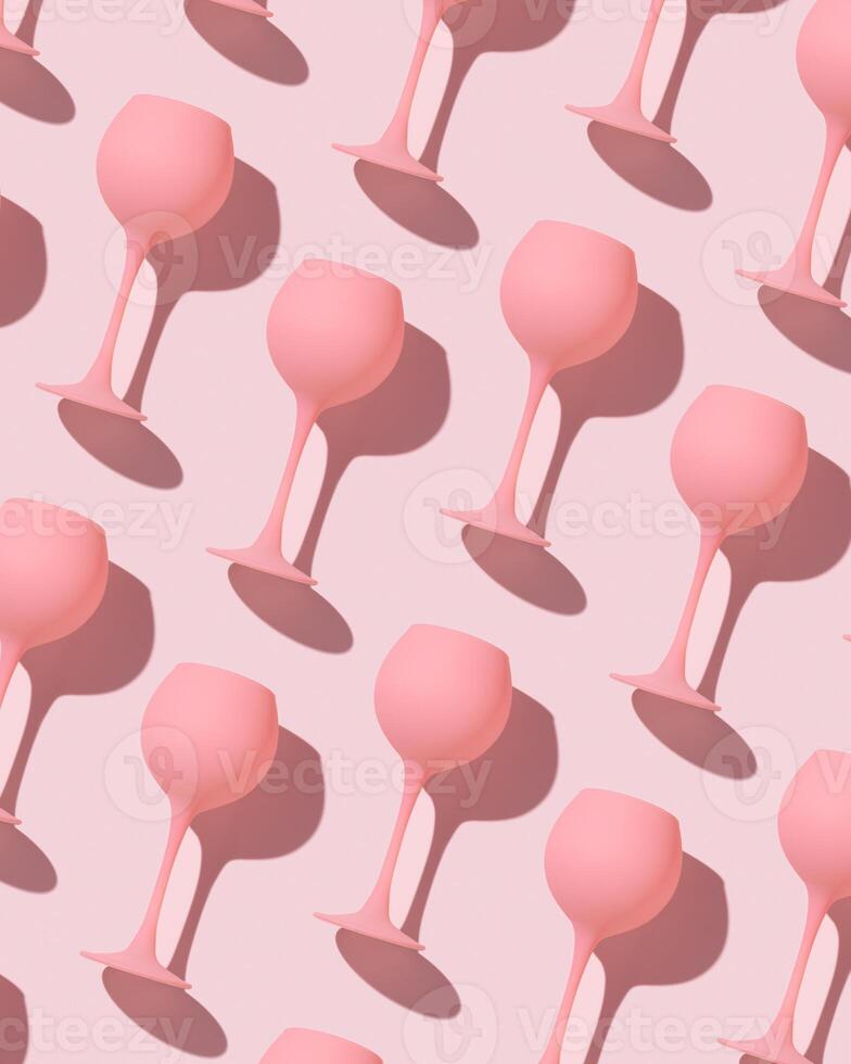 Minimal trend pattern from pink colored wine glasses on pastel pink background, monochrome geometric stylish layout of goblets. Entertainment, event, party concept. Abstract alcohol drinks photo