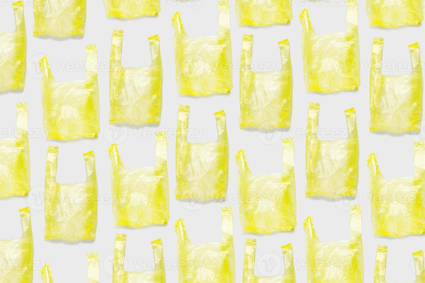 Top view pattern from Yellow plastic bags. Single-use polythene packet, Eco trend to reduce disposable plastics, Biodegradable packaging waste, creative photo pattern as design backgroun