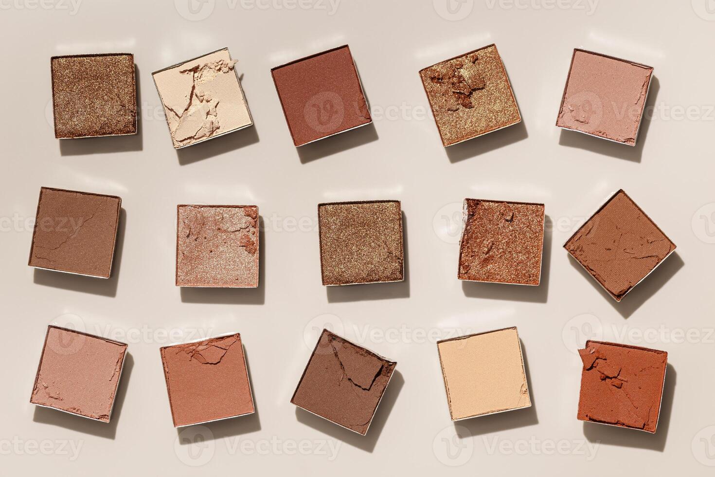 Beauty product neutral color eyeshadows for makeup, beige monochrome pattern on light background, flat lay with nude colors swatches eyeshade, cosmetic texture, beige tonespalette, top view pattern photo