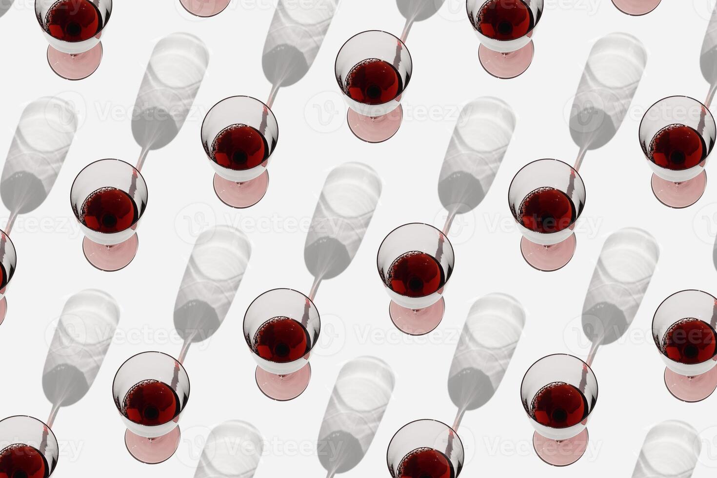 Minimal summer pattern with glasses of red wine, sunlight shadow on white background. Wine glasses flat lay, alcohol drinks modern photo. Holidays, parties, events, relaxation concept. Top view photo