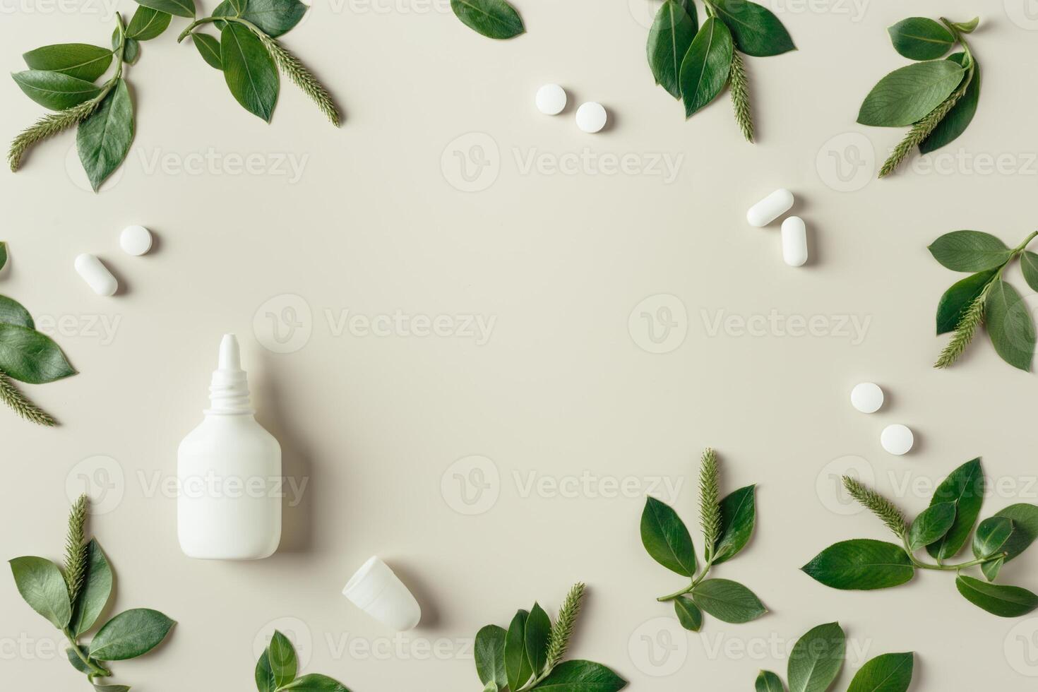 Seasonal allergy concept, spring young branches tree with new green leaves and catkins, white nasal spray, medical pills on beige background, minimal creative top view, trend flat lay photo