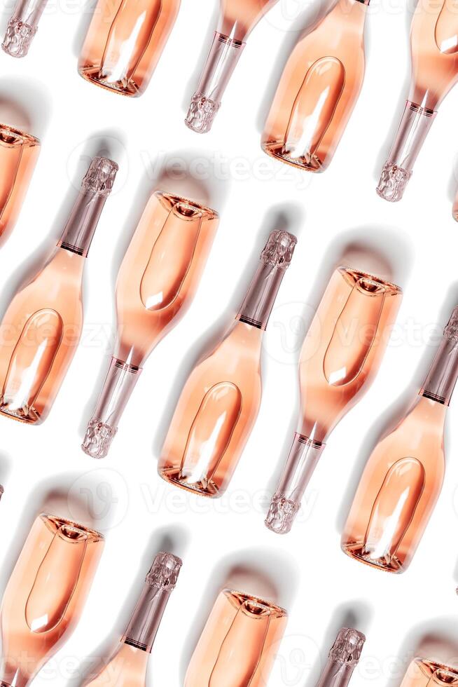Trend Aesthetic vertical pattern of bottles of rose sparkling wine, glass champagne bottles close up, isolated on white Romance festive drink concept. Summer alcohol drinks wine list photo