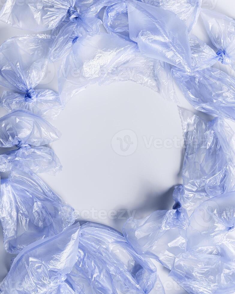 Plastic free environment protection concept. Empty used plastic bags, monochrome frame background, copy space. Aesthetic top view blue disposable polyethylene packet. Plastic bag free day photo