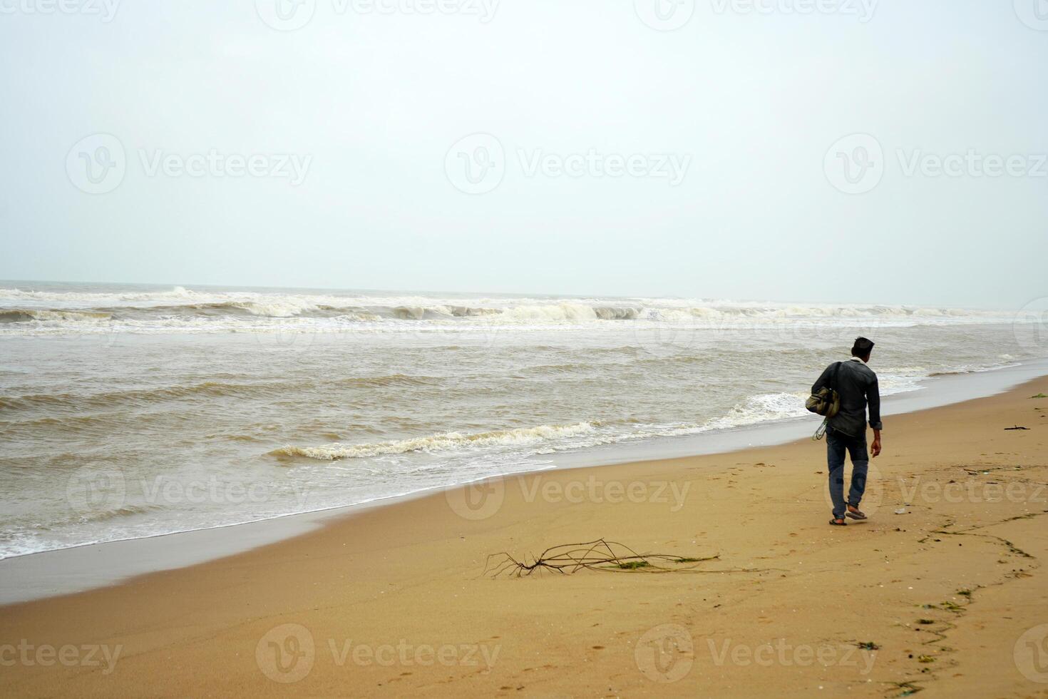 Lonely hawker at Puri sea beach during morning time photo