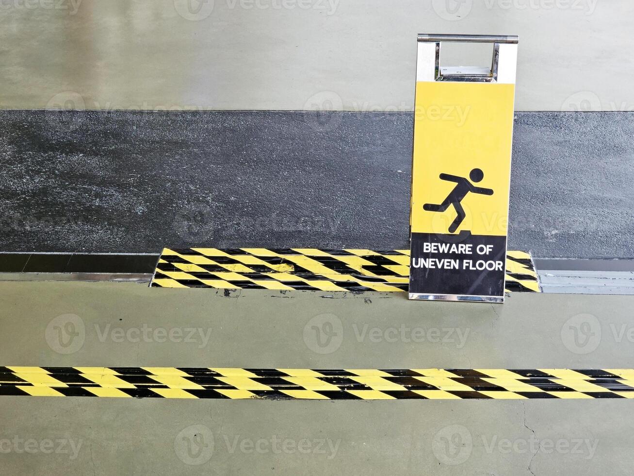 Beware of Uneven Floor Sign. photo