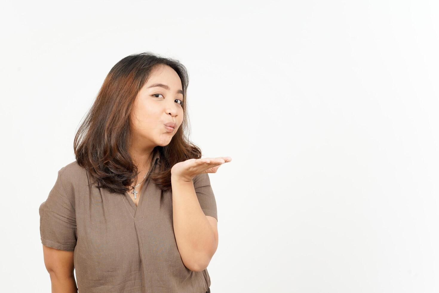 Asian woman blowing a kiss on white background photo