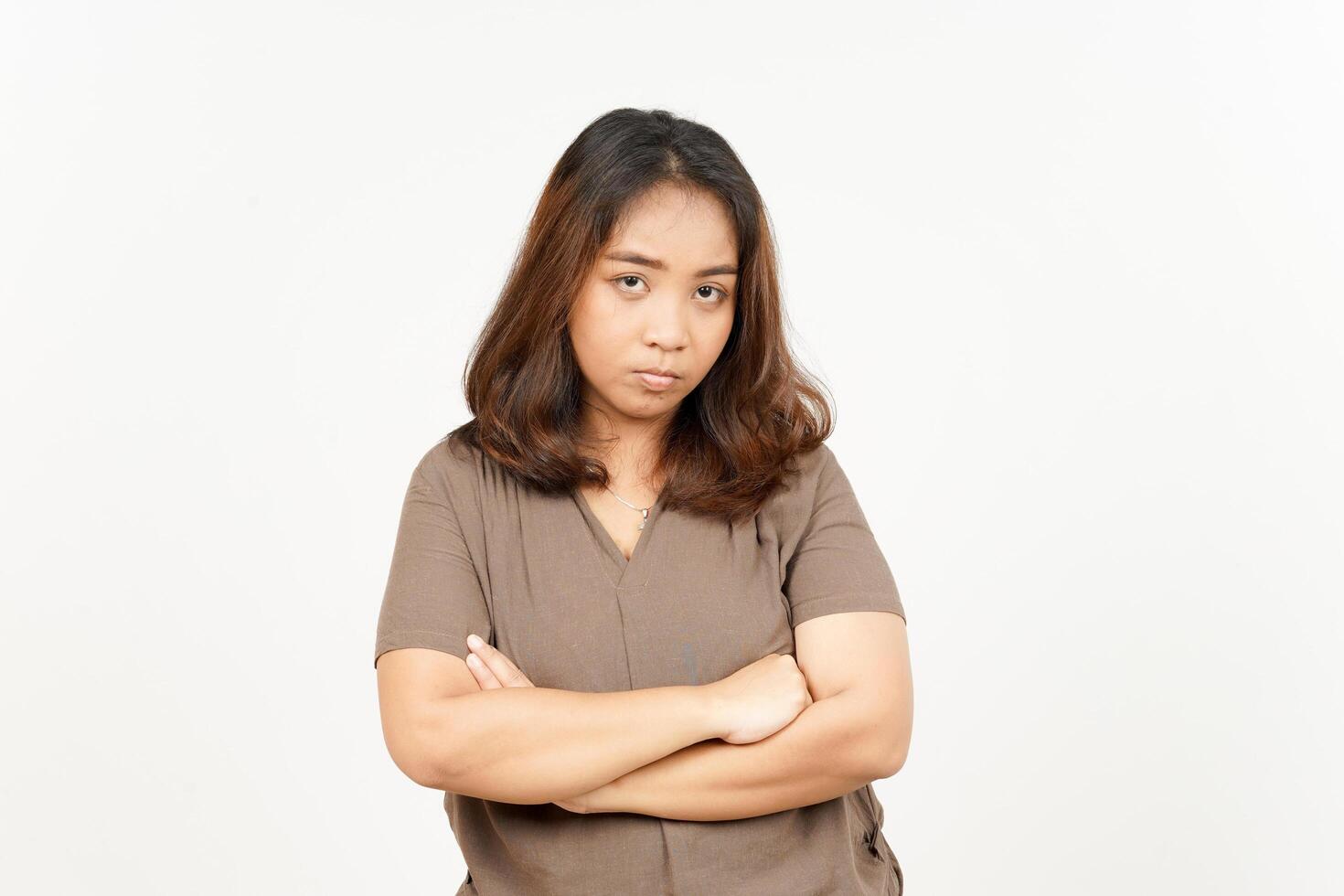 A woman in a brown shirt standing with her arms crossed photo