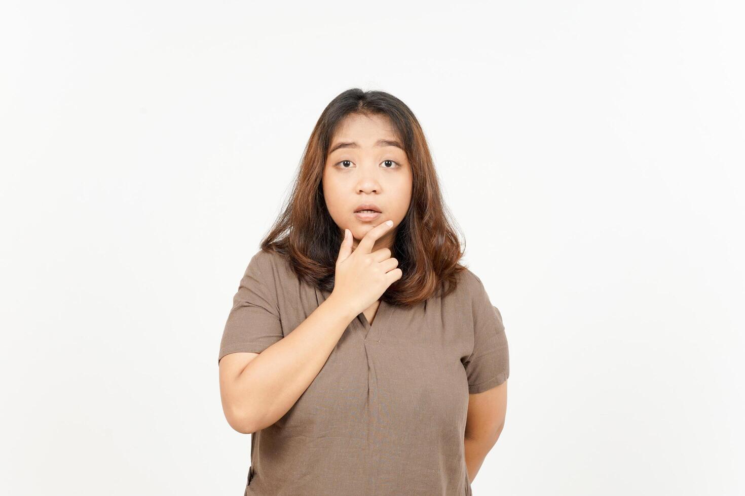 A woman is standing with her hand on her chin photo
