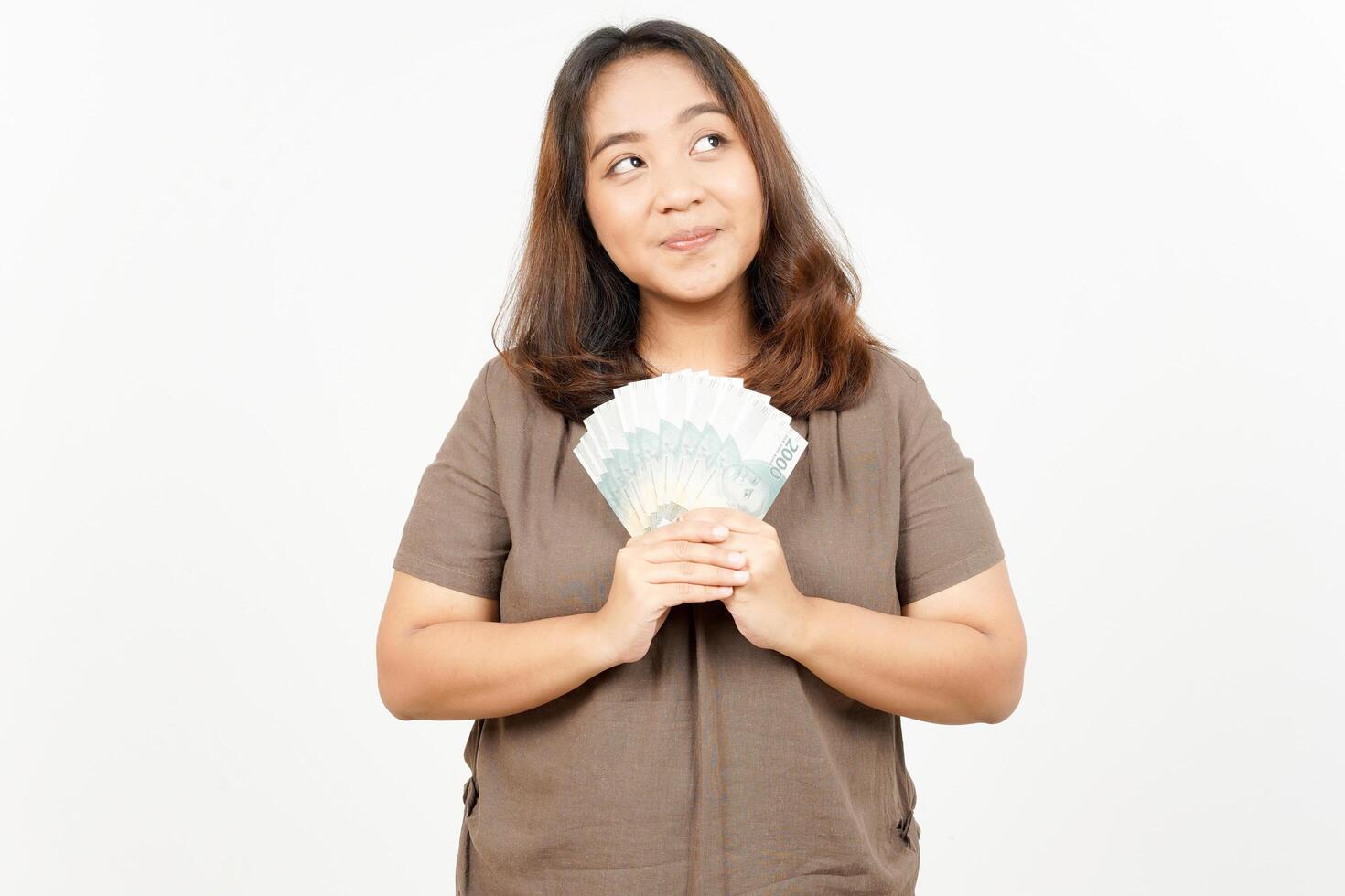 Asian woman holding money in hand and looking at camera photo