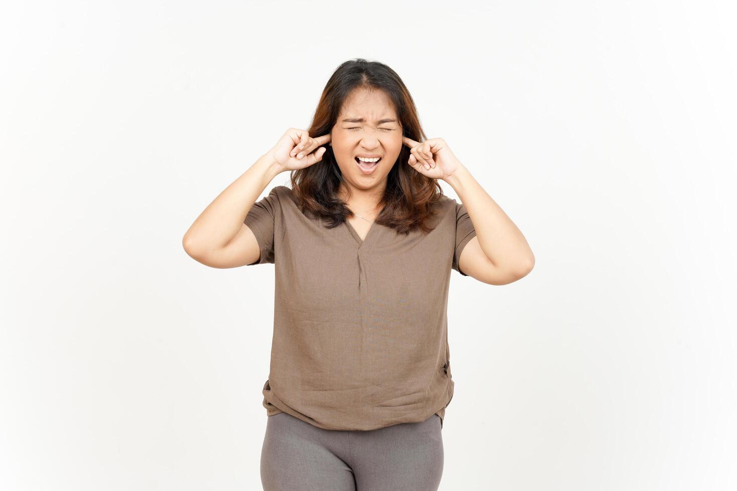 A woman is holding her hands to her ears photo