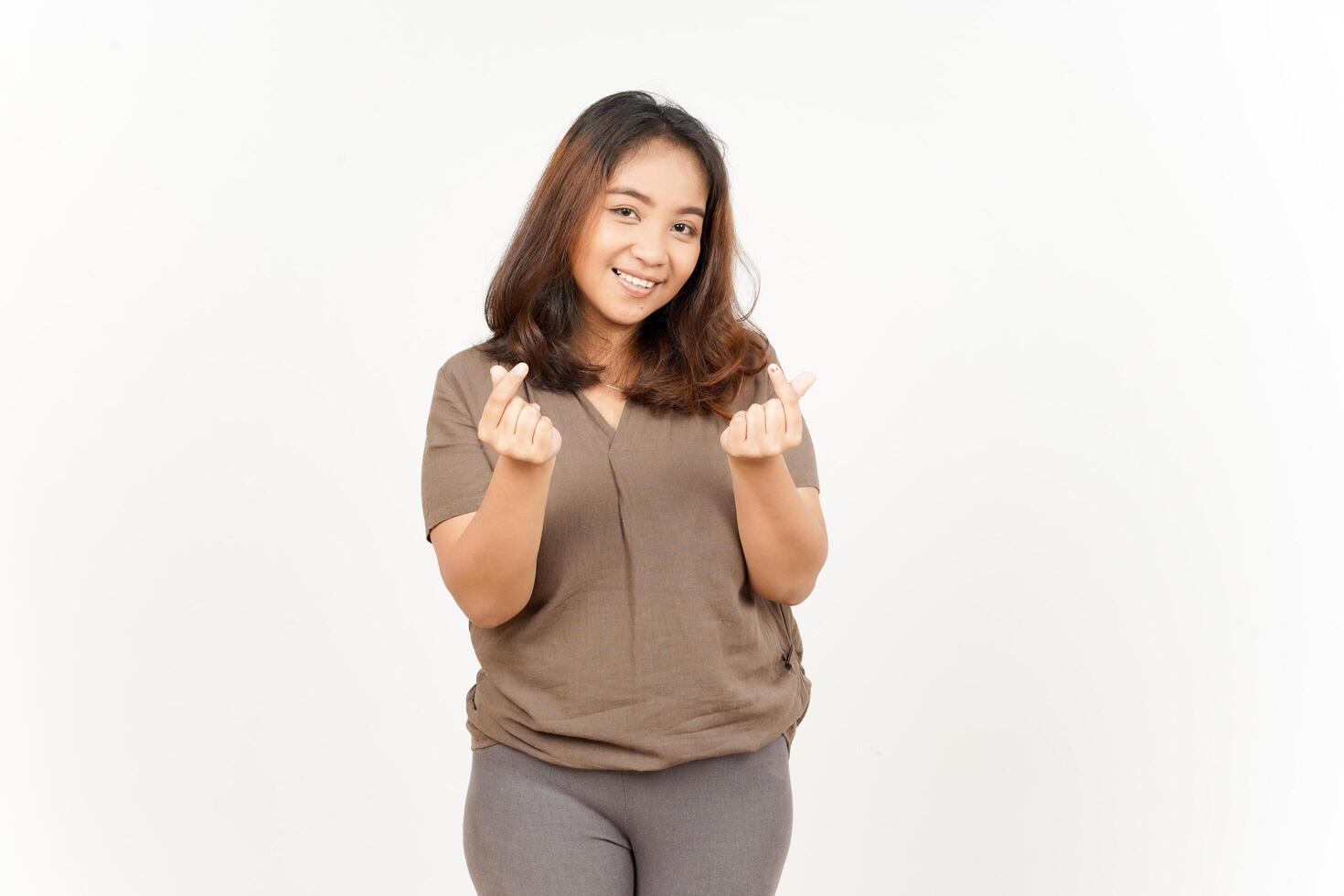 A woman in gray pants and a brown shirt is making a gesture photo