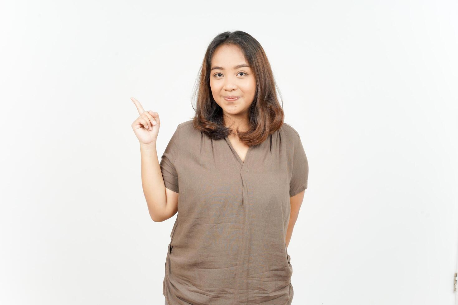 Asian woman pointing finger up on white background photo