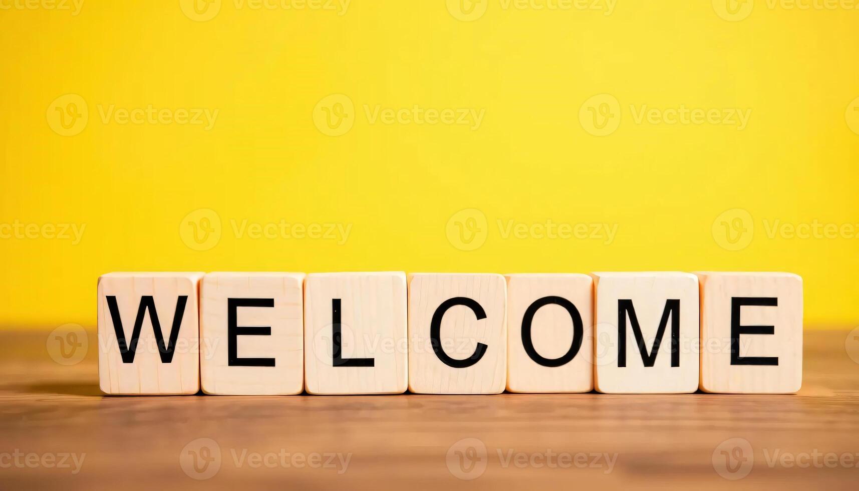Welcome Message on Wooden Blocks Against Yellow Background photo