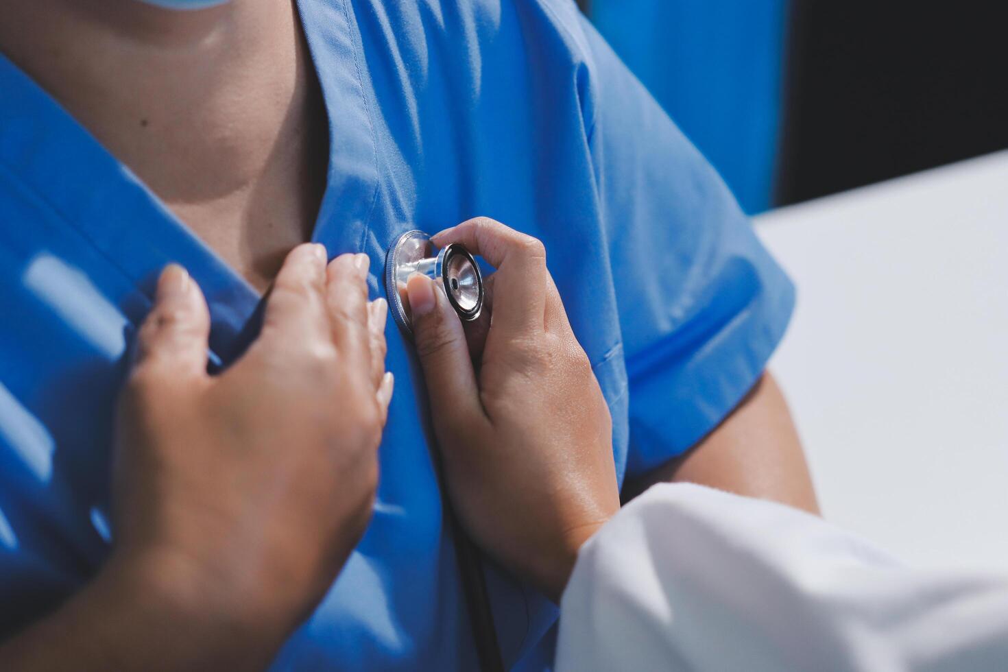 A doctor is checking a patient's heart rate photo