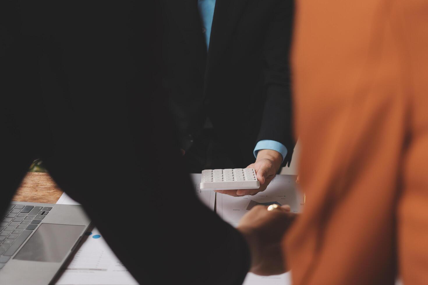 Business people holding a calculator and a laptop photo
