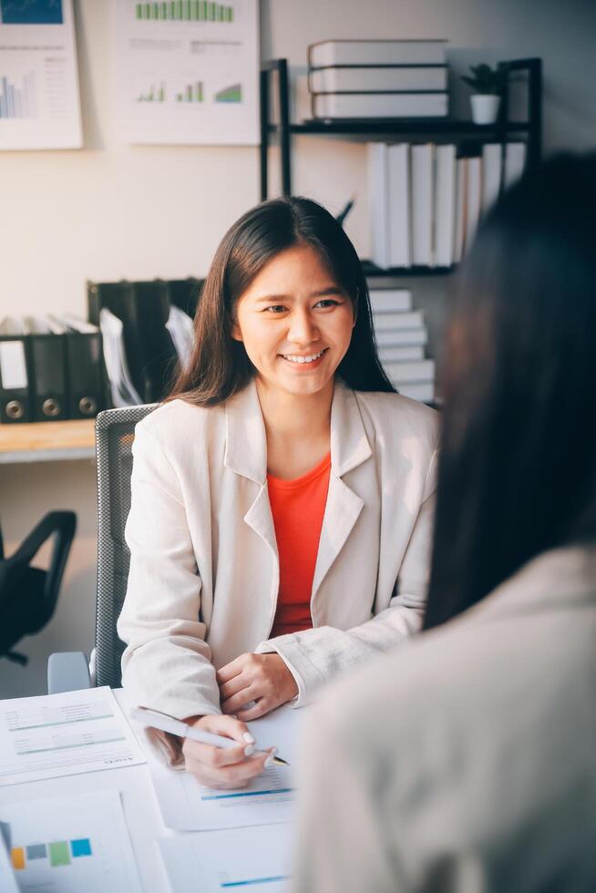 A woman in a business suit is talking to another woman photo