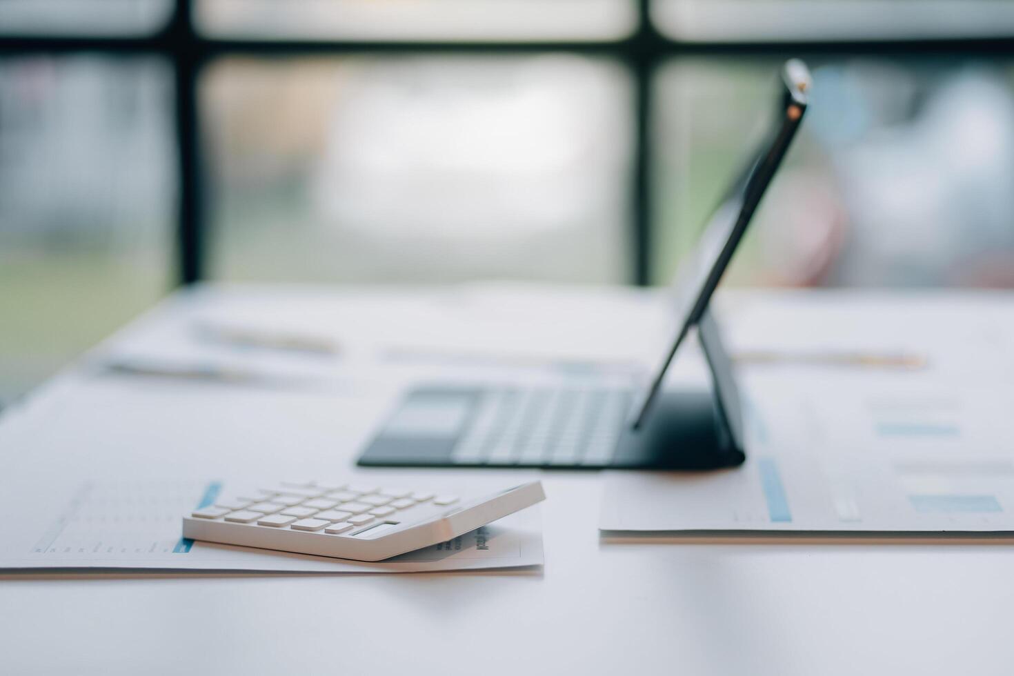 A laptop and a calculator on a desk photo