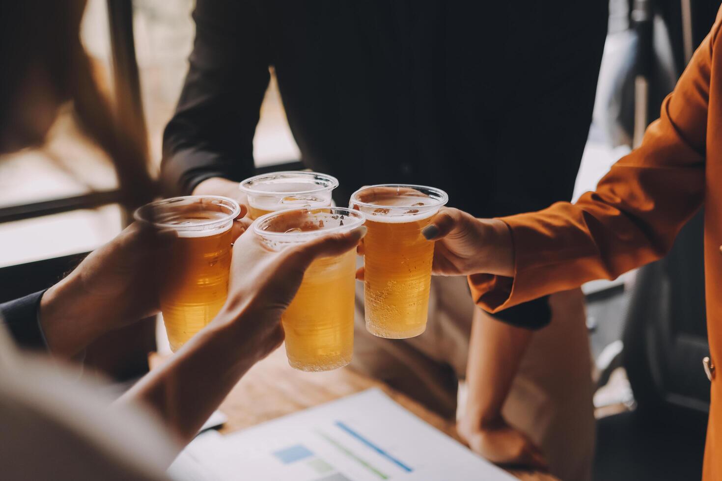 A group of people toasting with beer glasses photo