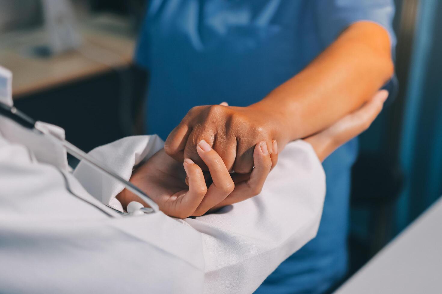A doctor holding the hand of a patient photo