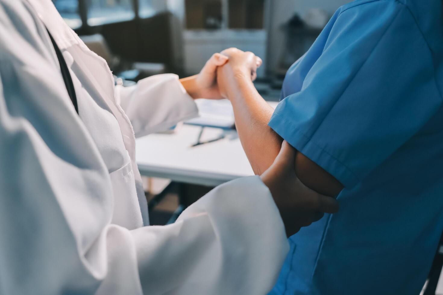 A doctor is shaking hands with a patient photo