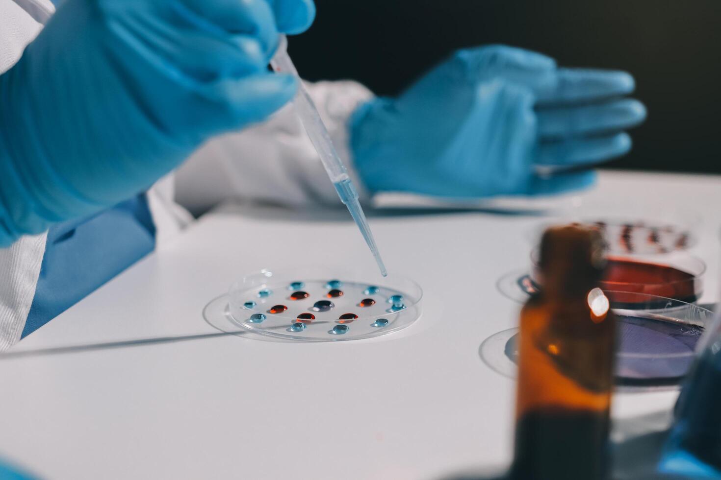 A person in a lab coat is holding a tube photo