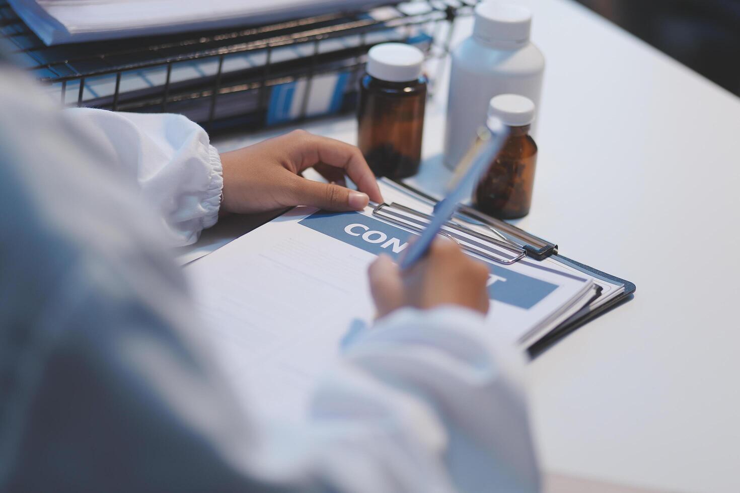 A doctor's hand writing on a medical prescription photo