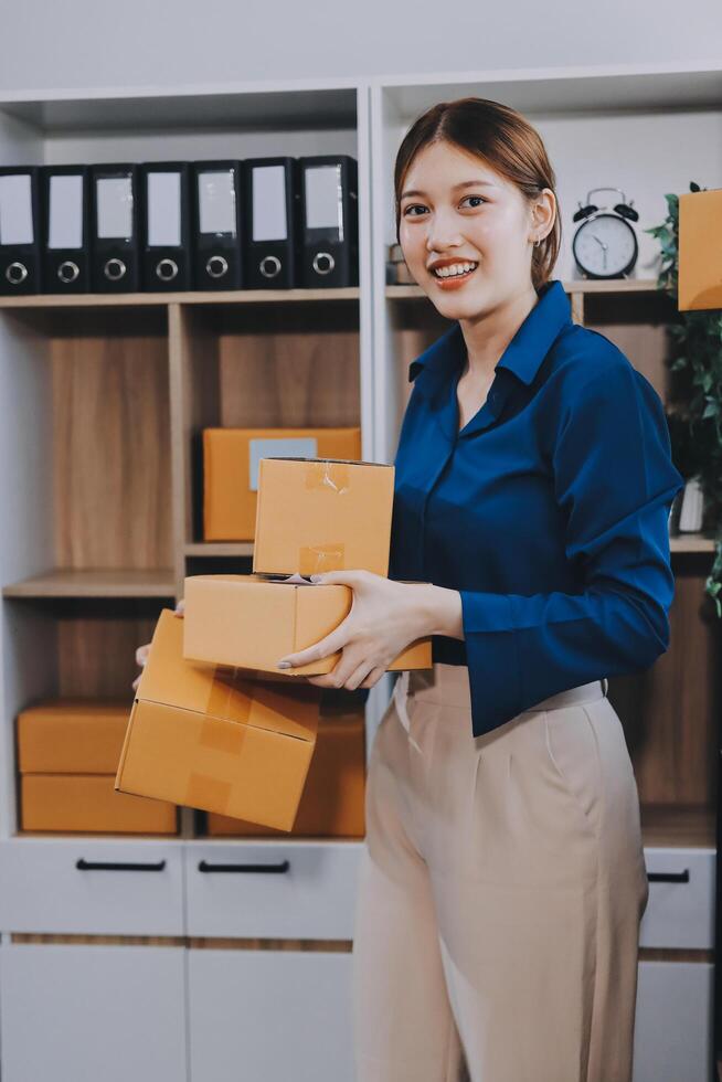 A woman holding boxes in an office photo