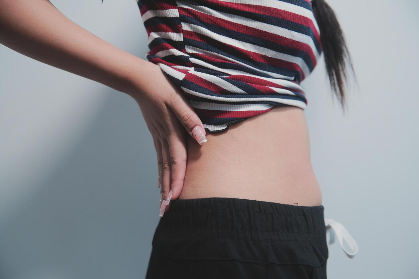 A woman with her hands on her stomach photo