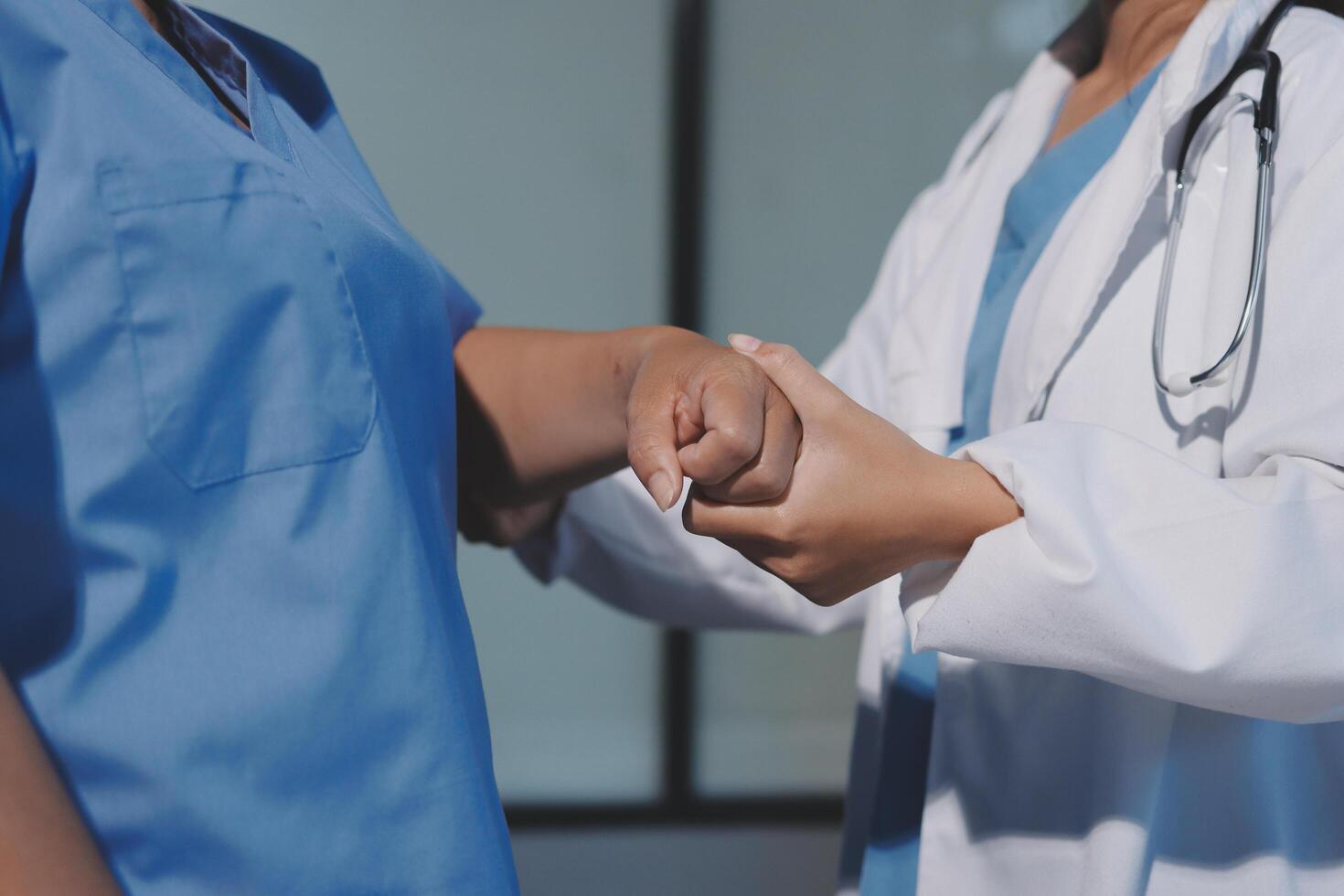A doctor is holding the hand of another person photo