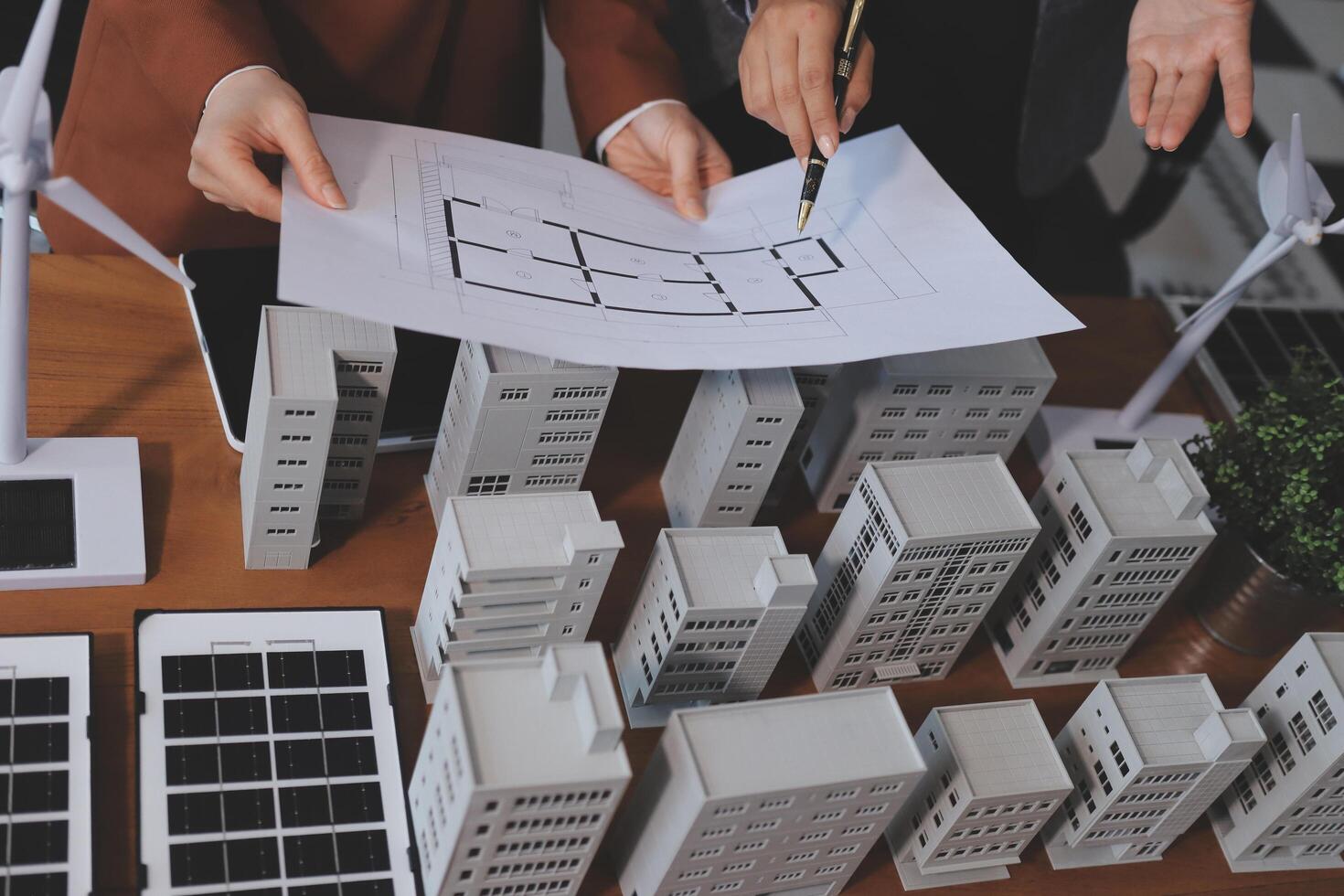 Two people are looking at a blueprint of a building photo