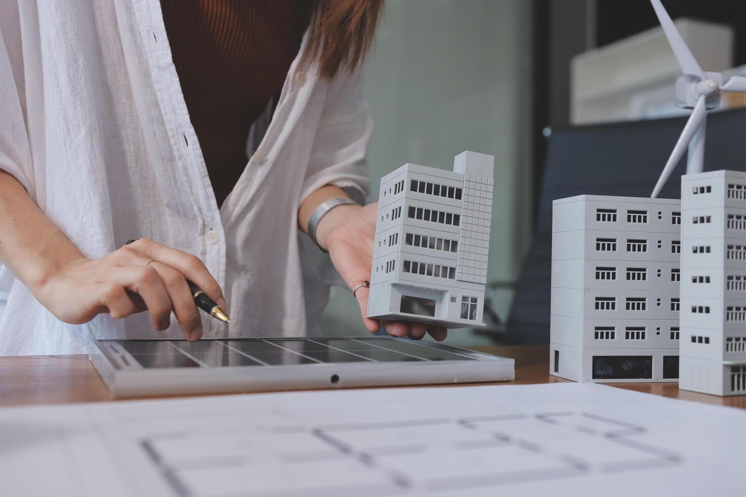 A woman is working on a building model photo