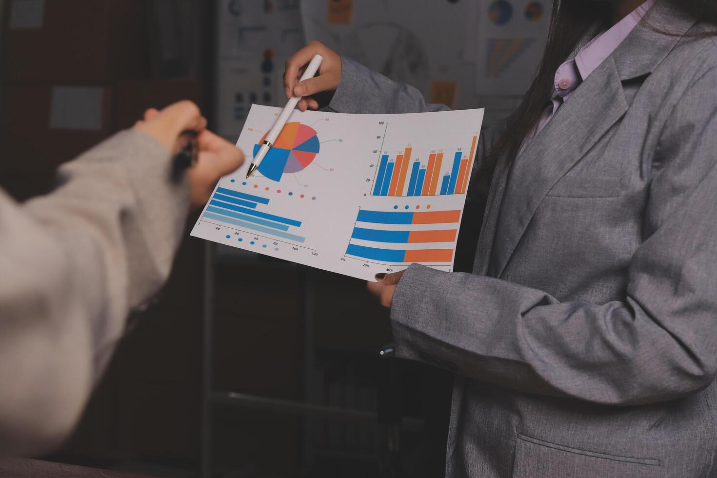 A business person is holding a piece of paper with graphs on it photo