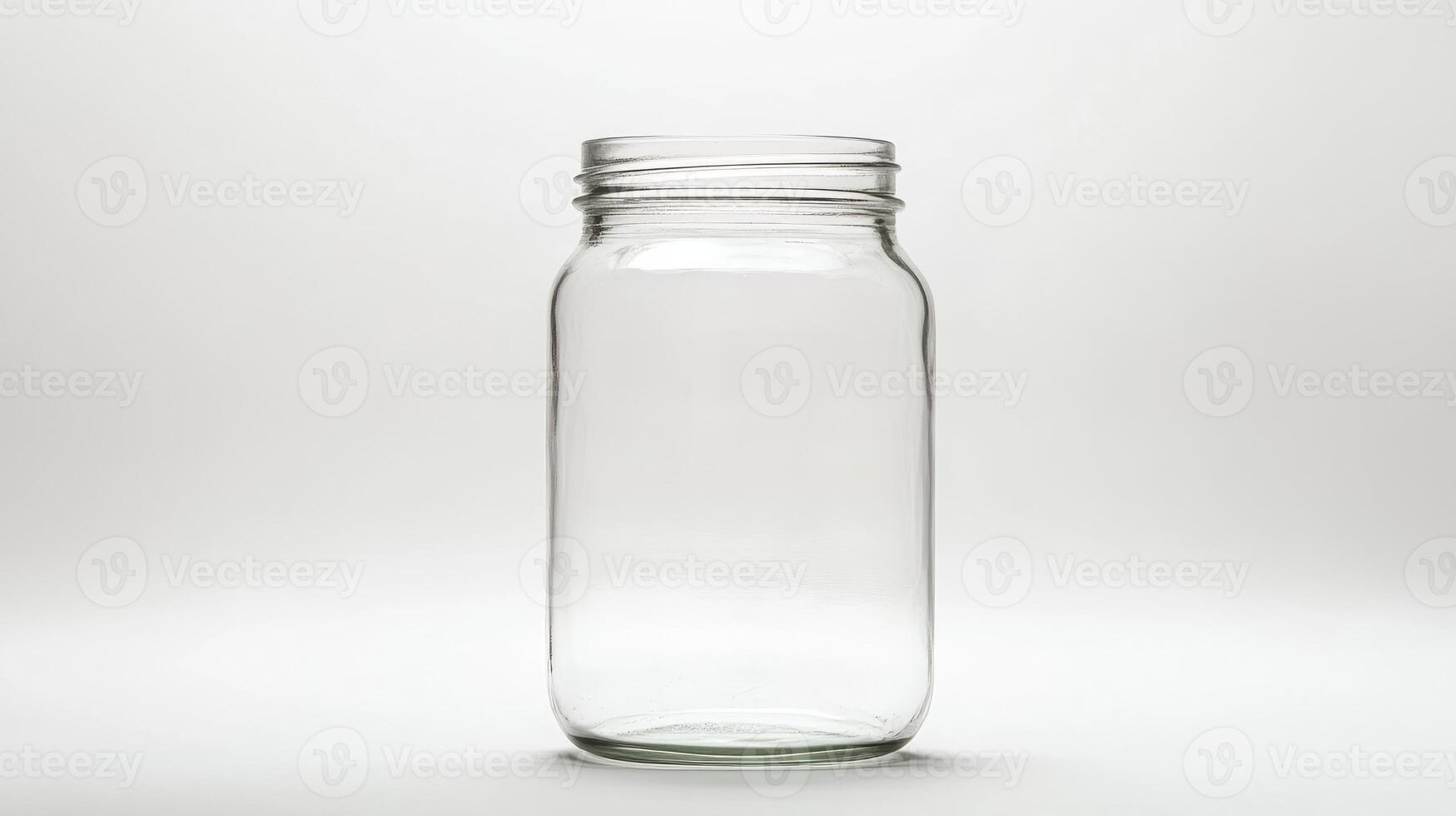 A high-resolution image of a clear glass mason jar against a white background, ideal for kitchen and storage themes. photo