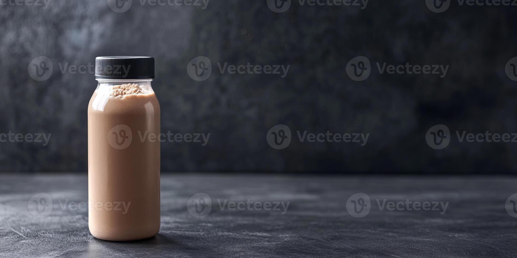 Brown beverage in a glass bottle set against a textured dark background. Ideal for showcasing nutrition, health, and tasty drink options in various settings. photo