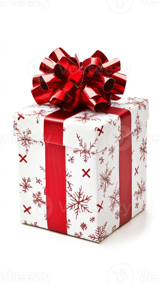 White box with red ribbon and snowflake designs. The box is a gift and is placed on a white background photo