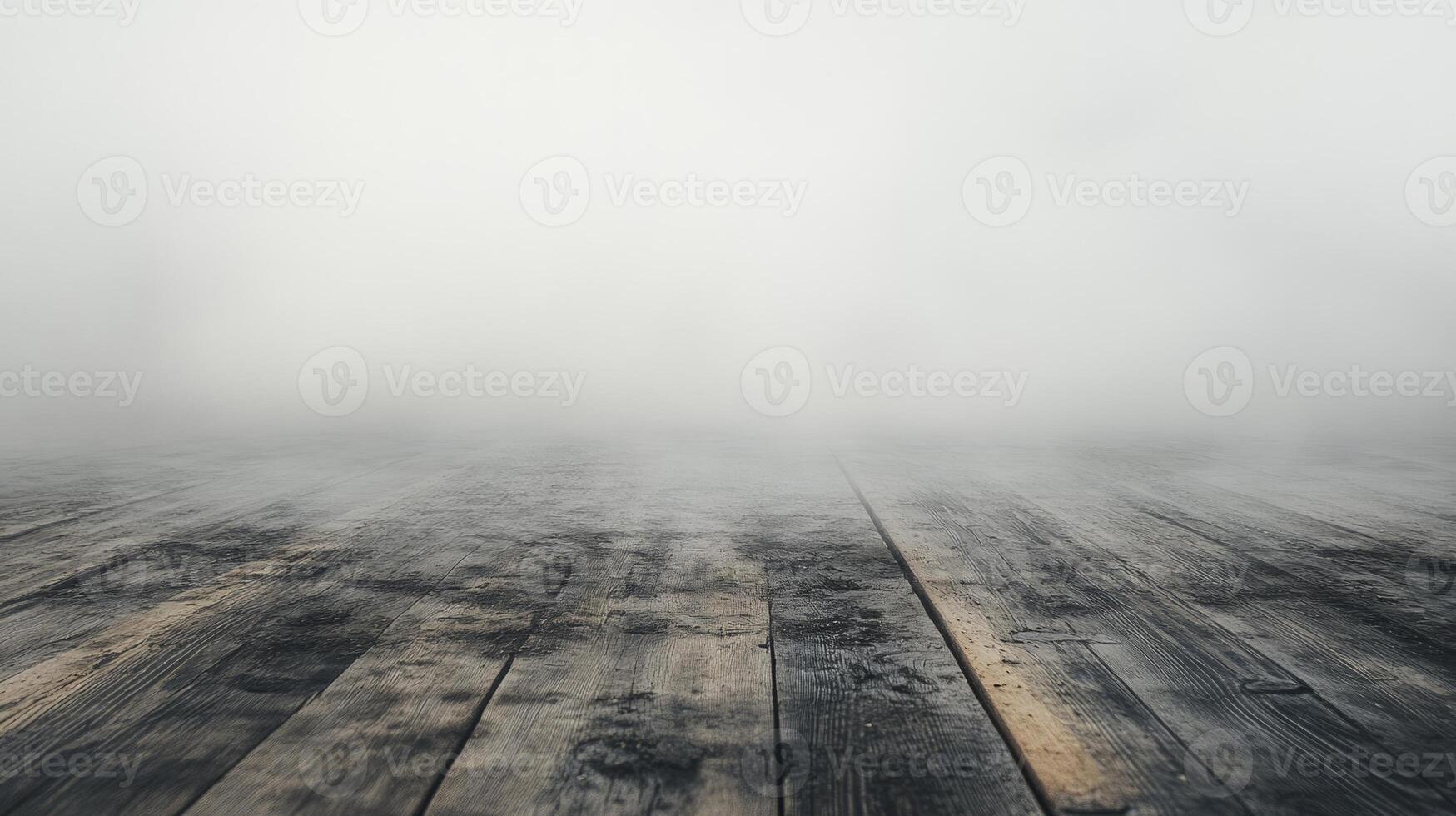 A misty scene featuring weathered wooden floorboards disappearing into dense fog, evoking a sense of mystery and tranquility. photo