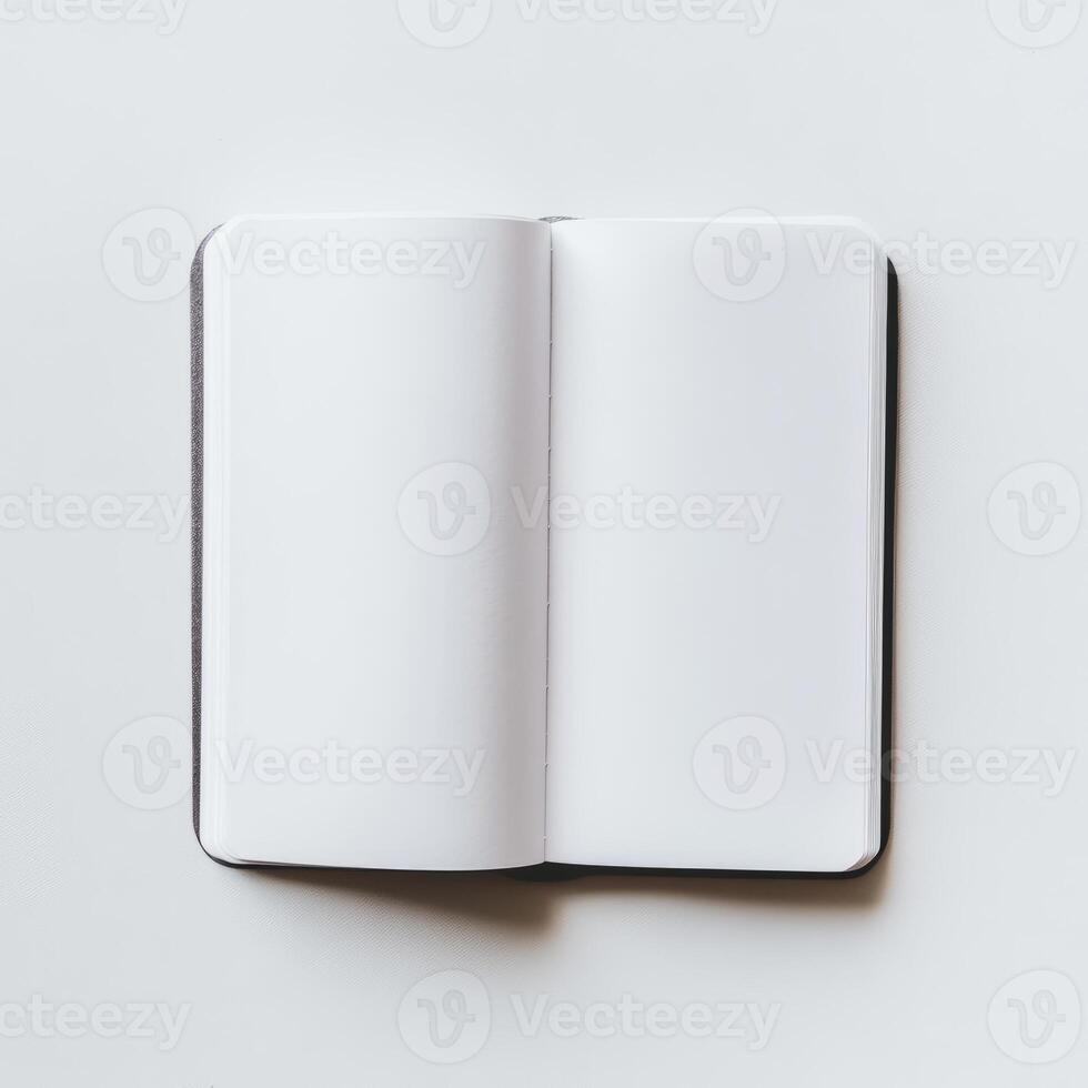 A top-down view of an open blank notebook on a white surface, ideal for themes of creativity, planning, or minimalism. photo