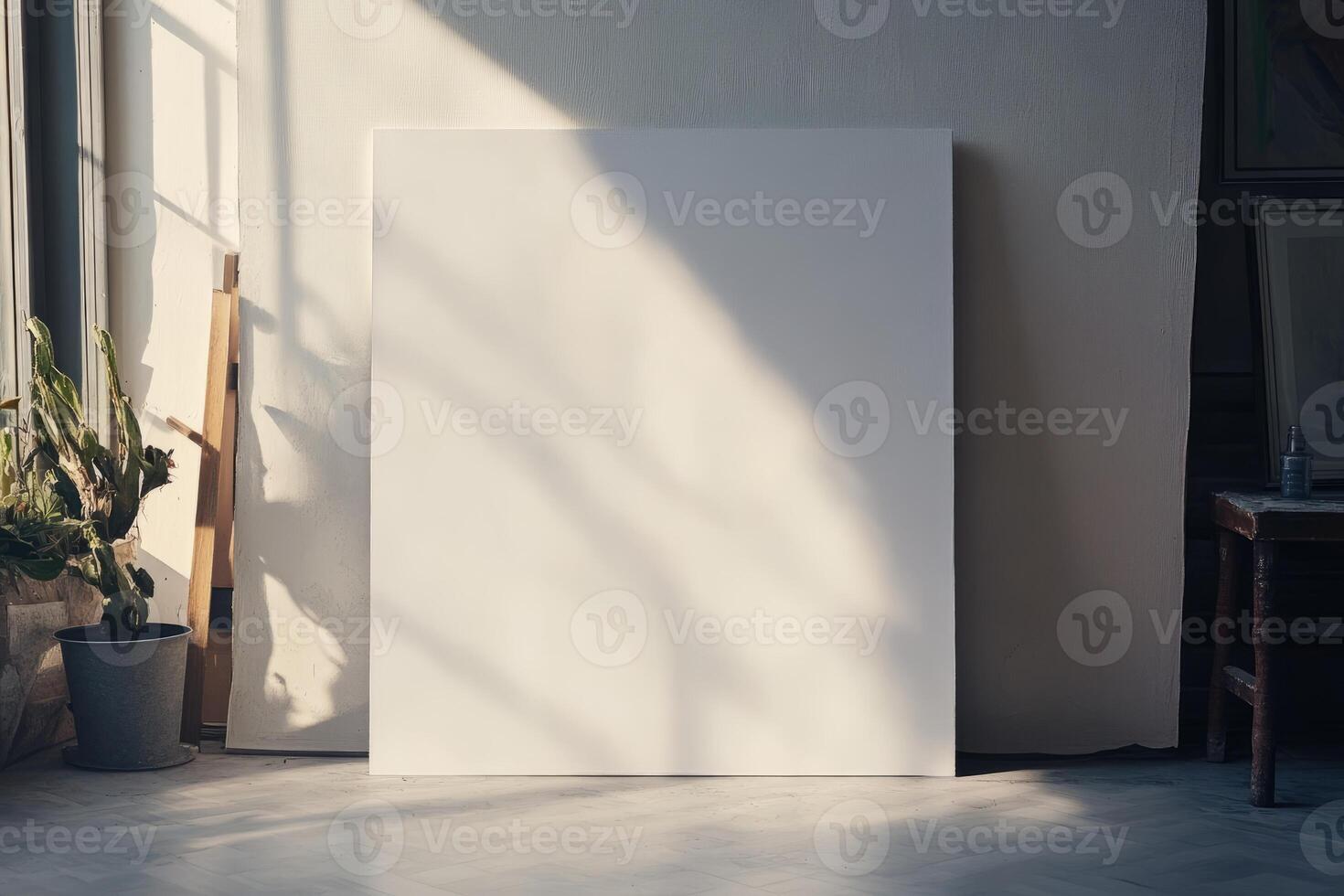 A blank canvas in an artist's studio, illuminated by natural sunlight, casting shadows on the wall and floor. photo