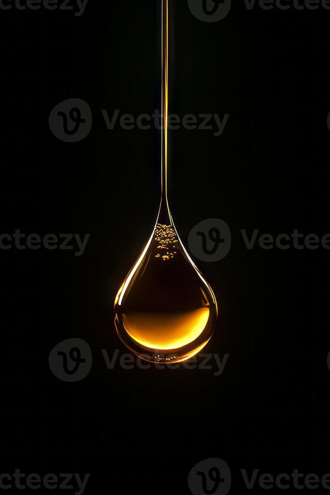 A single golden oil drop suspended against a dark background, showcasing elegance and simplicity in a minimalist style. photo